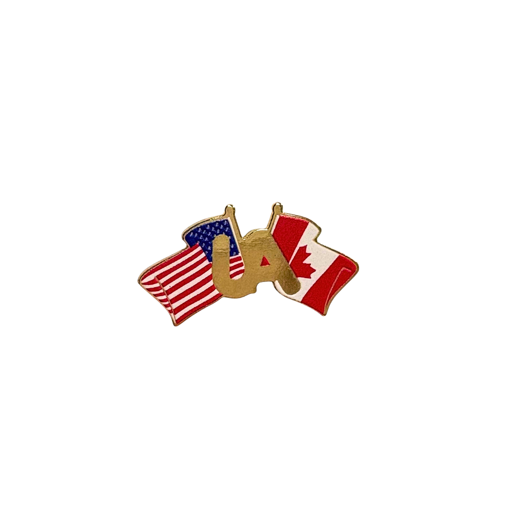 Gold UA lapel pin with crossed American and Canadian flags on a white backgroun